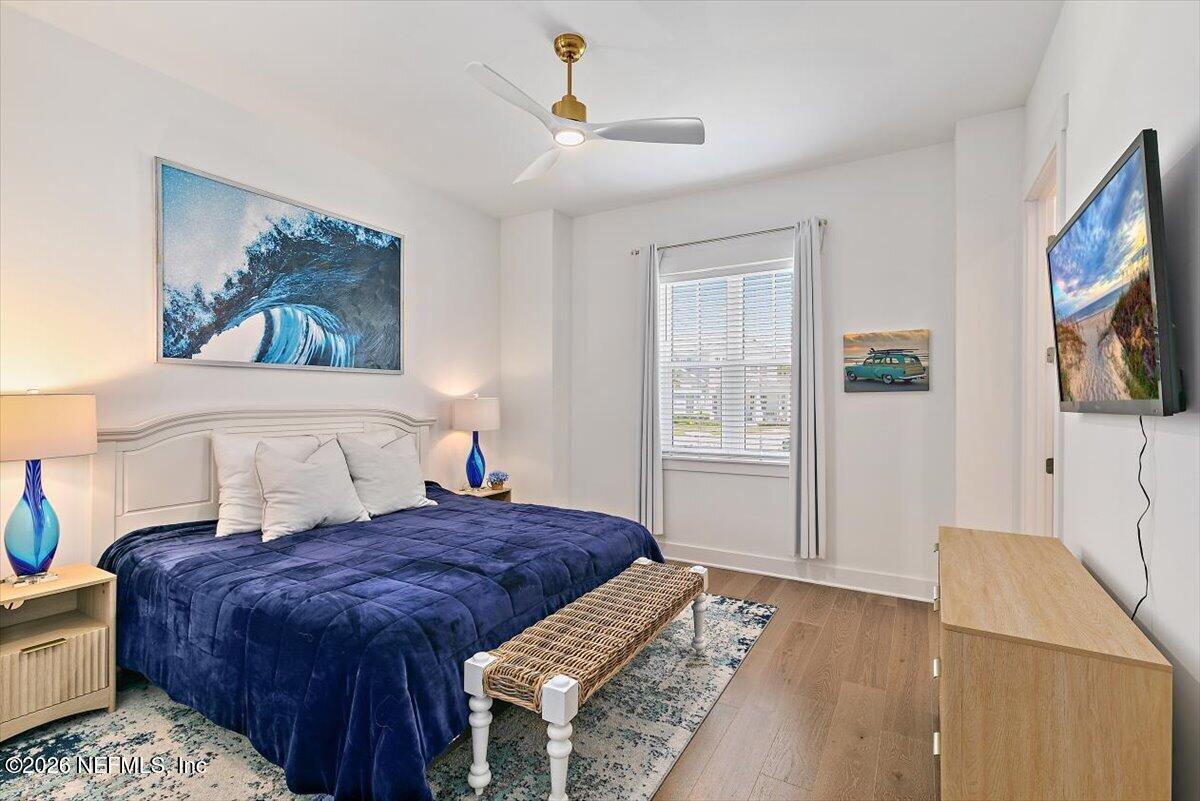 556 Timber Bridge Lane Atlantic Beach, FL 32233 - Photo 37 of 71 a spacious bedroom with a large bed a chandelier and a flat tv screen on a dresser