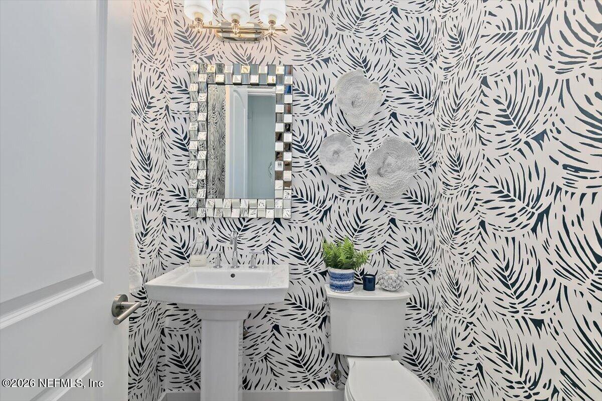 556 Timber Bridge Lane Atlantic Beach, FL 32233 - Photo 40 of 71 a bathroom with a sink and mirror with toilet