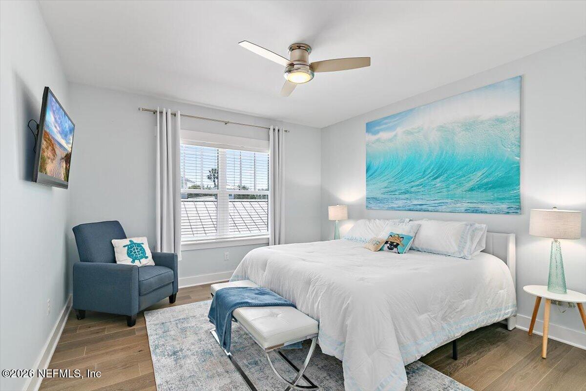556 Timber Bridge Lane Atlantic Beach, FL 32233 - Photo 49 of 71 a bedroom with a bed and wooden floor