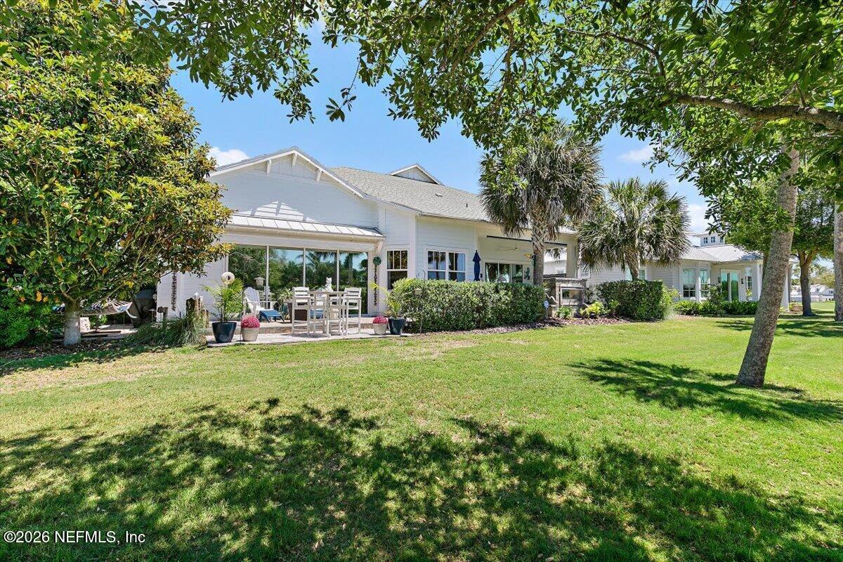 556 Timber Bridge Lane Atlantic Beach, FL 32233 - Photo 57 of 71 a view of a house with a big yard and large trees