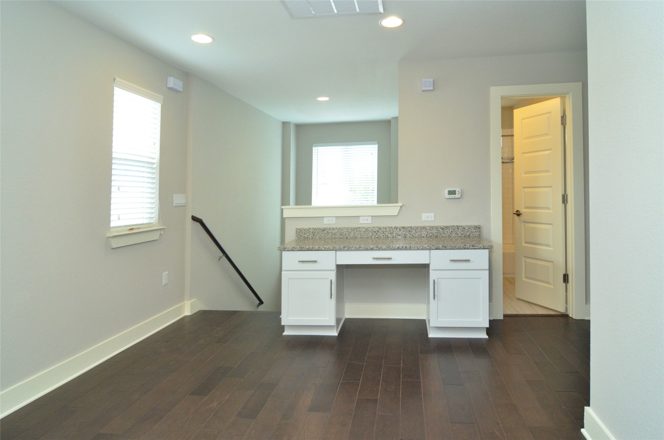 1916 Cleese Drive Austin, TX 78741 - Photo 20 of 36 A versatile open-concept space features warm hardwood flooring and a functional built-in desk with elegant granite counters.