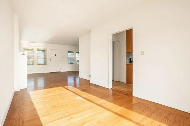 a view of kitchen and hallway with wooden floor
