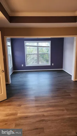 a view of room with window and wooden floor