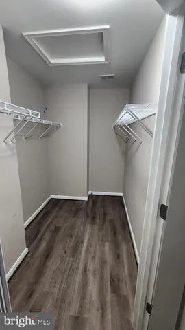 a view of a room with wooden floor and white walls