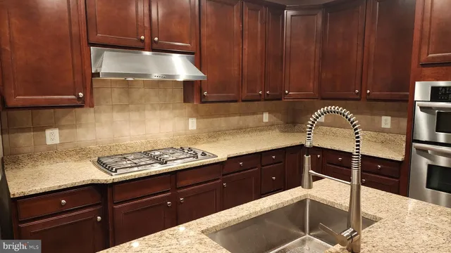 a kitchen with granite countertop a cabinets and stove