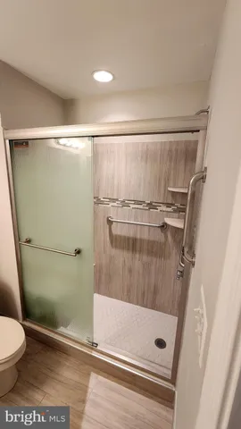 a bathroom with a shower and a toilet