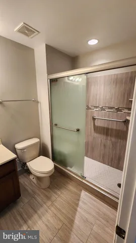 a bathroom with a toilet and a shower