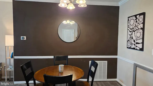 a view of a dining room with furniture and chandelier
