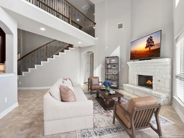 a living room with furniture fireplace and flat screen tv