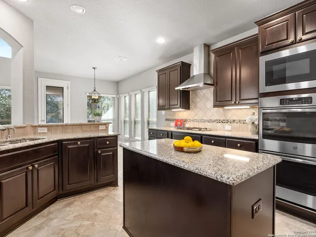 a kitchen with a sink a stove and cabinets