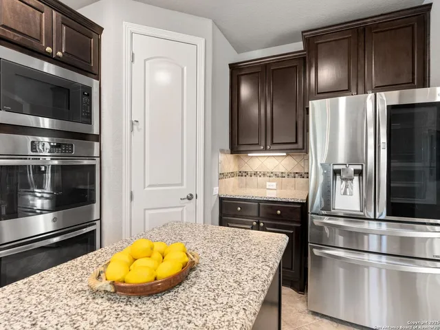 a kitchen with a refrigerator and microwave