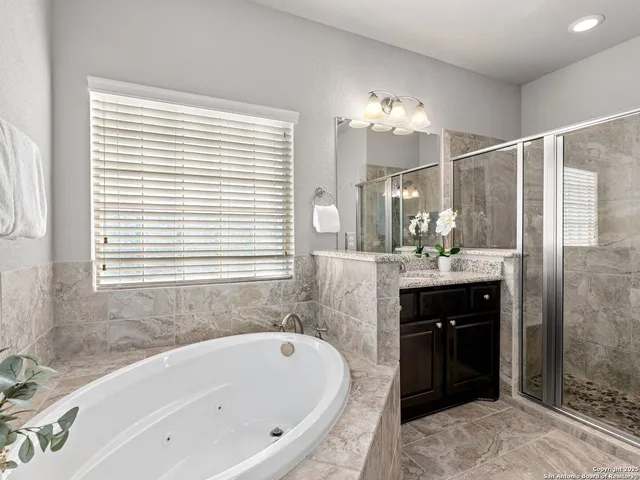 a bathroom with a bathtub sink and mirror