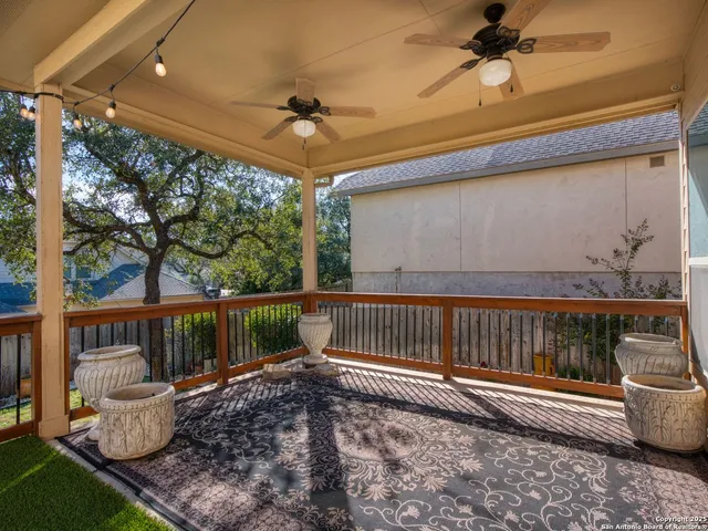 a view of a chair and table on the green field