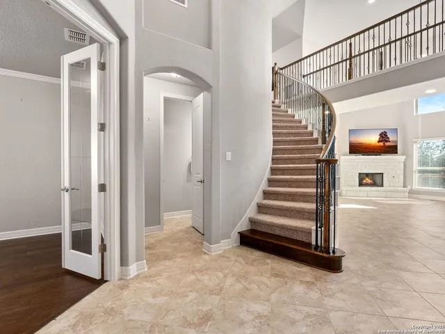 a view of a hallway with a door and stairs