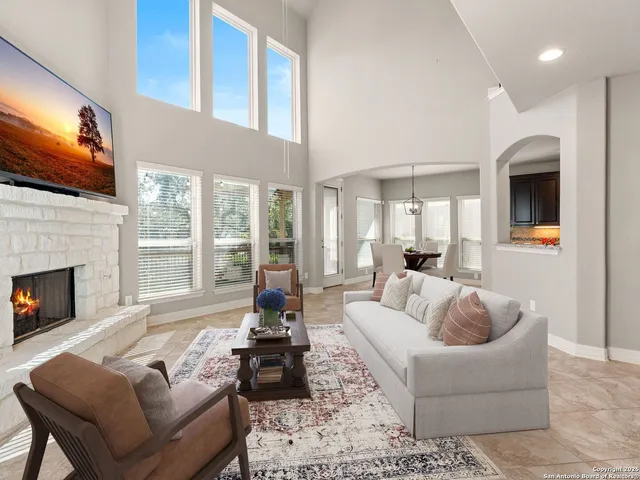 a living room with furniture fireplace and flat screen tv