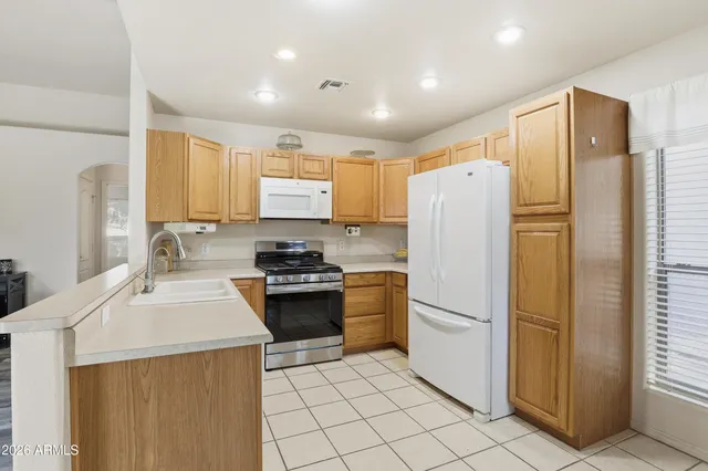 a kitchen with stainless steel appliances a refrigerator stove microwave and sink
