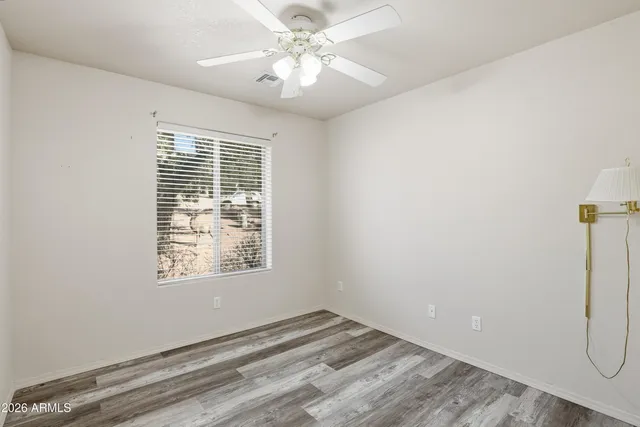 a view of a livingroom with a window and a ceiling fan