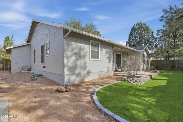 a view of a house with backyard and sitting area