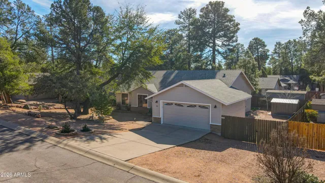 a view of a patio with a table and chairs under an umbrella