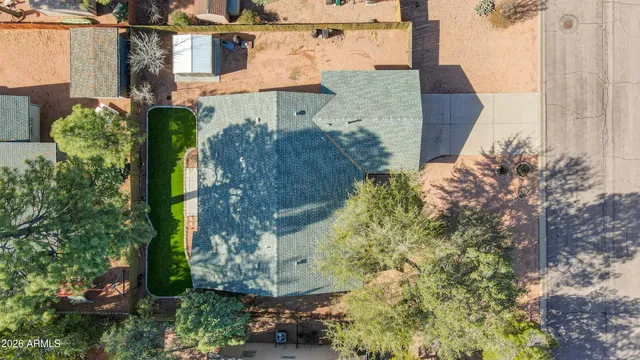 an aerial view of a house with a yard and large trees
