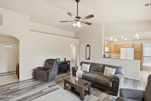 a living room with furniture and a chandelier