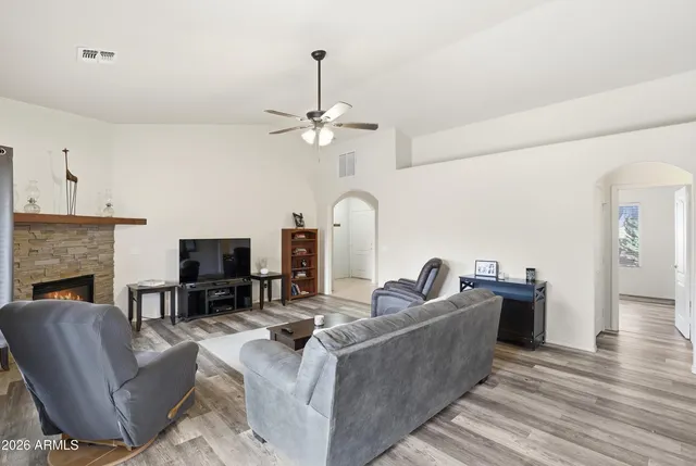 a living room with furniture a fireplace and a flat screen tv