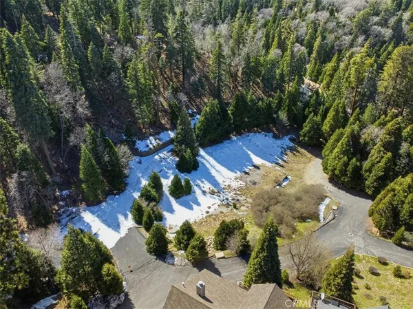an aerial view of a house with a yard basket ball court and outdoor seating