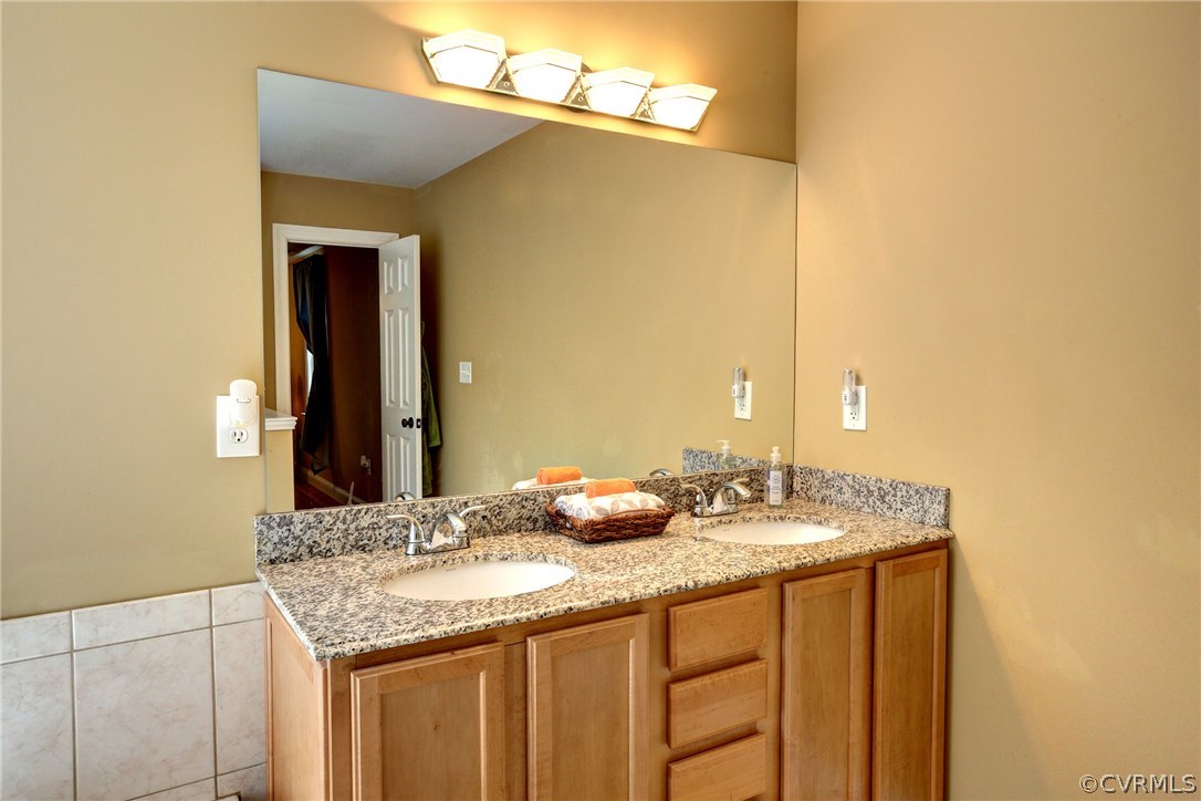 4947 Shannon Road Kents Store, VA 23084 - Photo 16 of 24 a bathroom with a granite countertop sink and a mirror