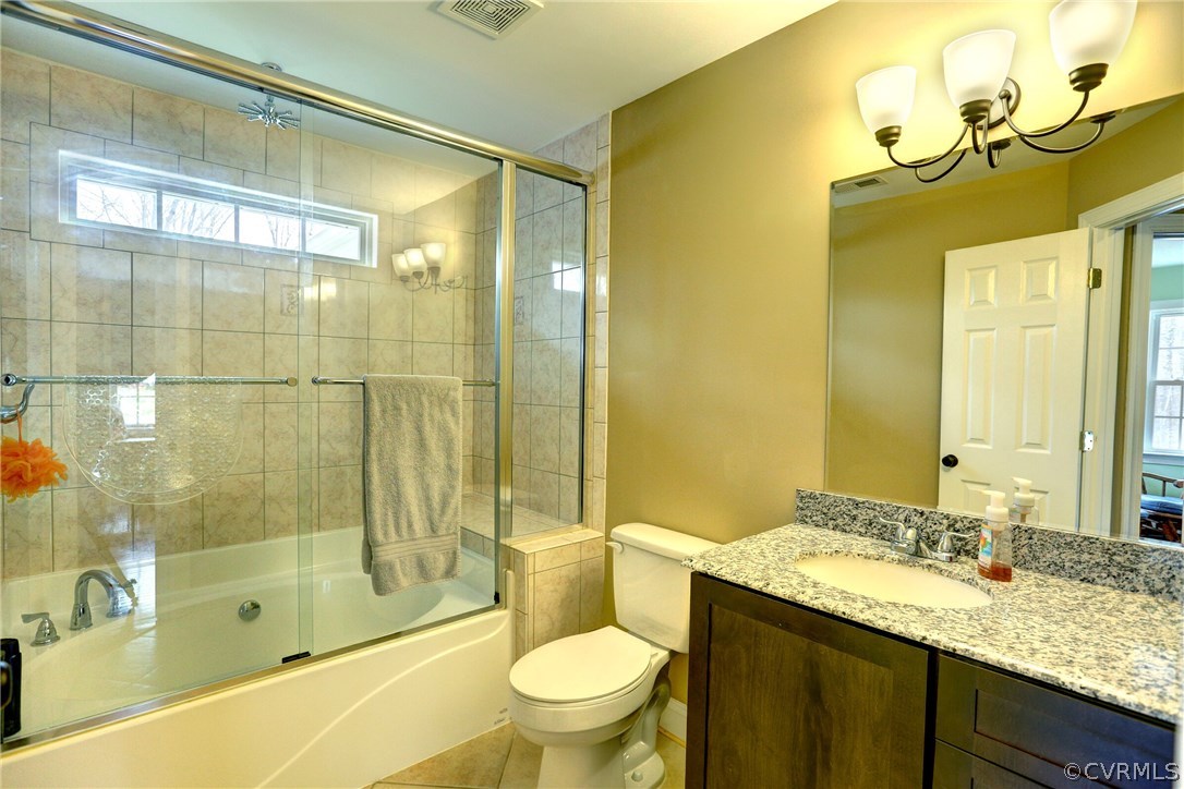 4947 Shannon Road Kents Store, VA 23084 - Photo 19 of 24 a bathroom with a granite countertop sink toilet and shower