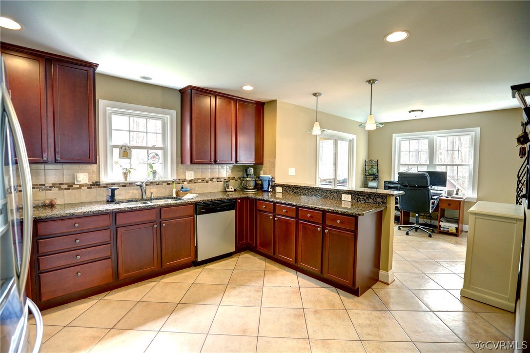 4947 Shannon Road Kents Store, VA 23084 - Photo 6 of 24 a kitchen with stainless steel appliances granite countertop wooden cabinets a stove a sink and a large window