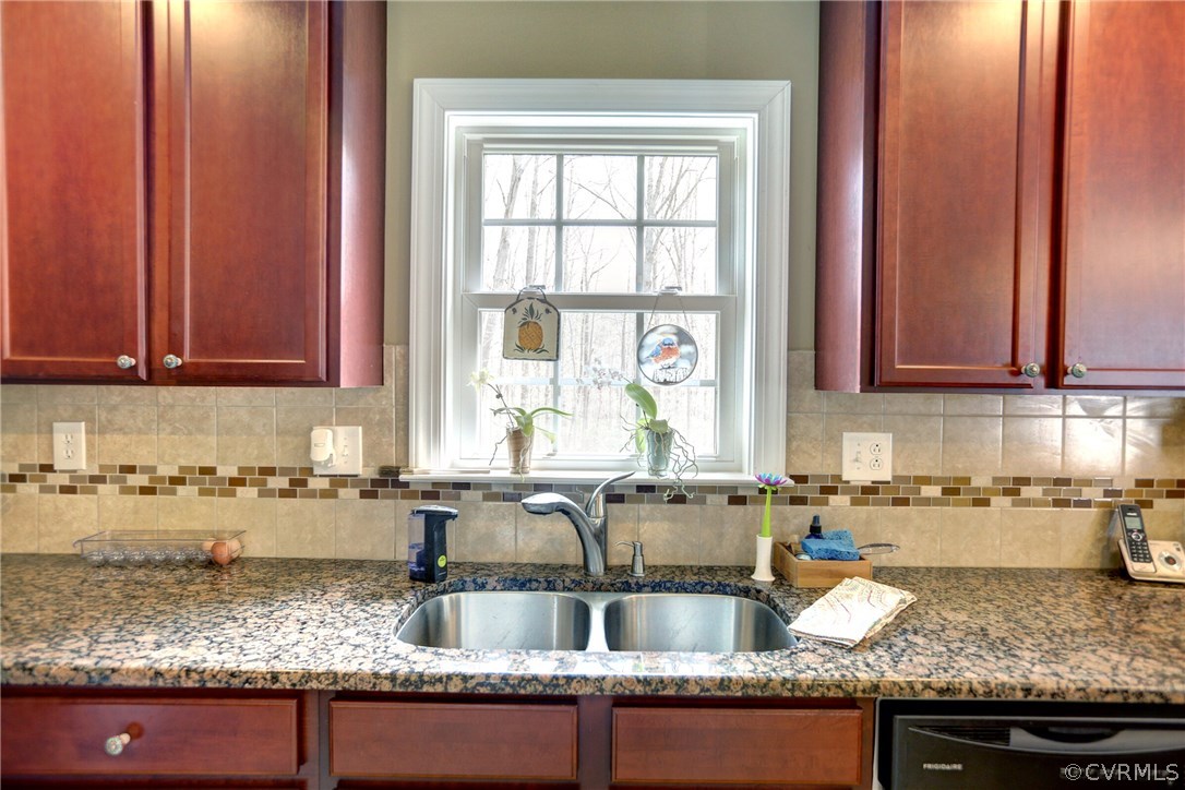 4947 Shannon Road Kents Store, VA 23084 - Photo 8 of 24 a kitchen with granite countertop a sink a stove and cabinets