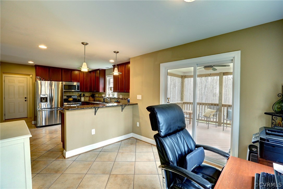 4947 Shannon Road Kents Store, VA 23084 - Photo 10 of 24 a kitchen with stainless steel appliances granite countertop a refrigerator a stove a sink a dining table and chairs with wooden floor