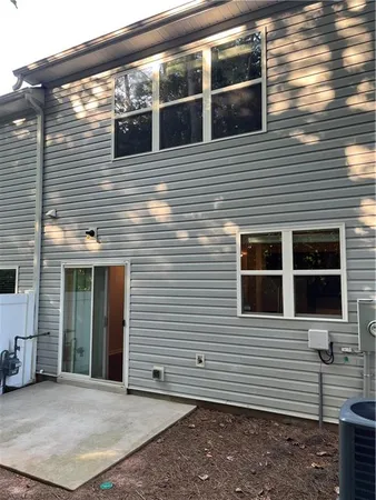 a view of a house with a door and a yard