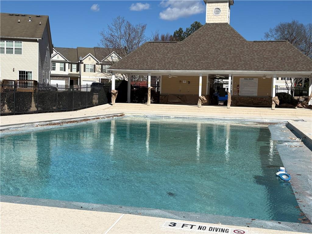 4720 Beacon Ridge Lane Flowery Branch, GA 30542 - Photo 20 of 20 a view of a white house with a swimming pool