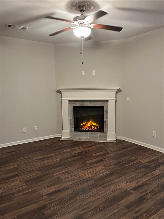 4720 Beacon Ridge Lane Flowery Branch, GA 30542 - Photo 2 of 20 a view of an empty room with wooden floor fireplace and a window