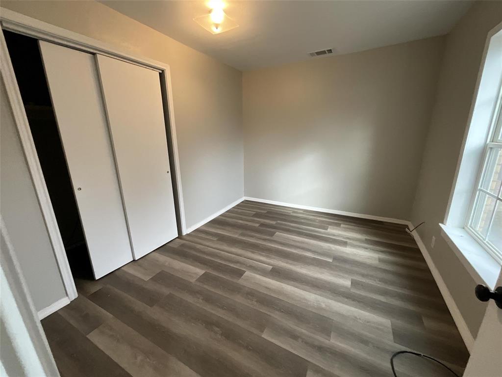 405 Beard Street Canton, TX 75103 - Photo 12 of 20 a view of empty room with wooden floor and fan