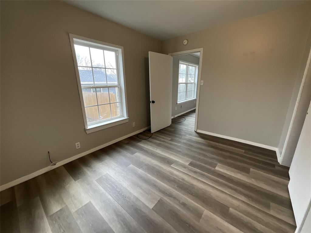 405 Beard Street Canton, TX 75103 - Photo 13 of 20 an empty room with wooden floor and windows