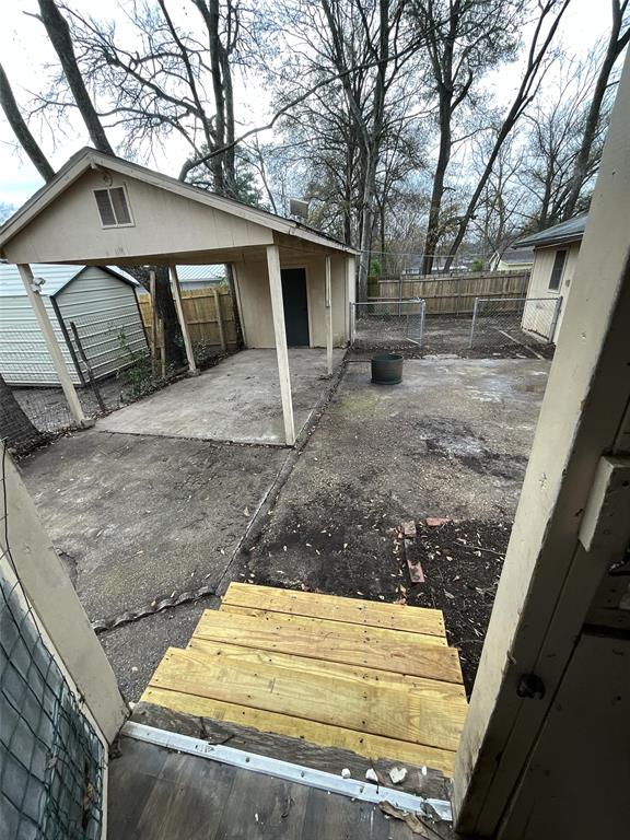 405 Beard Street Canton, TX 75103 - Photo 16 of 20 a view of a backyard that has a tree on the side of it