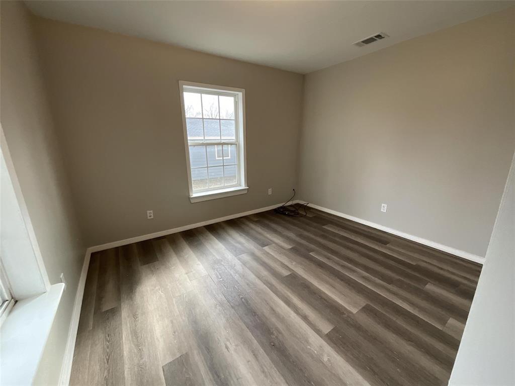 405 Beard Street Canton, TX 75103 - Photo 2 of 20 wooden floor in an empty room with a window