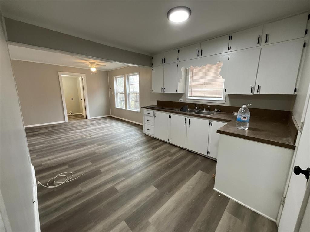 405 Beard Street Canton, TX 75103 - Photo 8 of 20 a kitchen with granite countertop a sink a stove cabinets and wooden floor