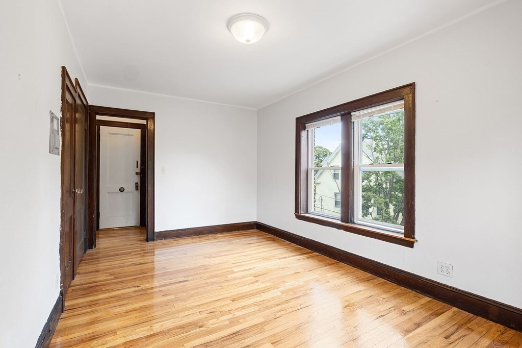 5 Haskell Street, Unit 31 Cambridge, MA 02140 - Photo 2 of 9 a view of an empty room with wooden floor and a window