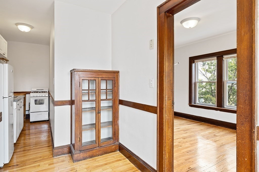 5 Haskell Street, Unit 31 Cambridge, MA 02140 - Photo 5 of 9 a view of an empty room with window and wooden floor