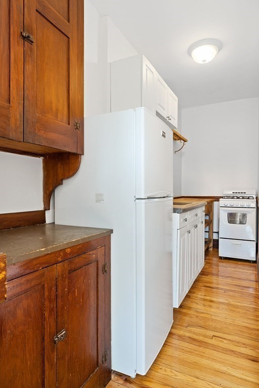 5 Haskell Street, Unit 31 Cambridge, MA 02140 - Photo 6 of 9 a kitchen with stainless steel appliances granite countertop a refrigerator a stove and a sink