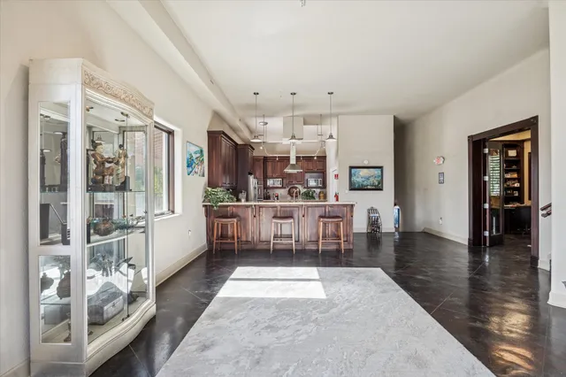 a bathroom with a granite countertop toilet and a sink