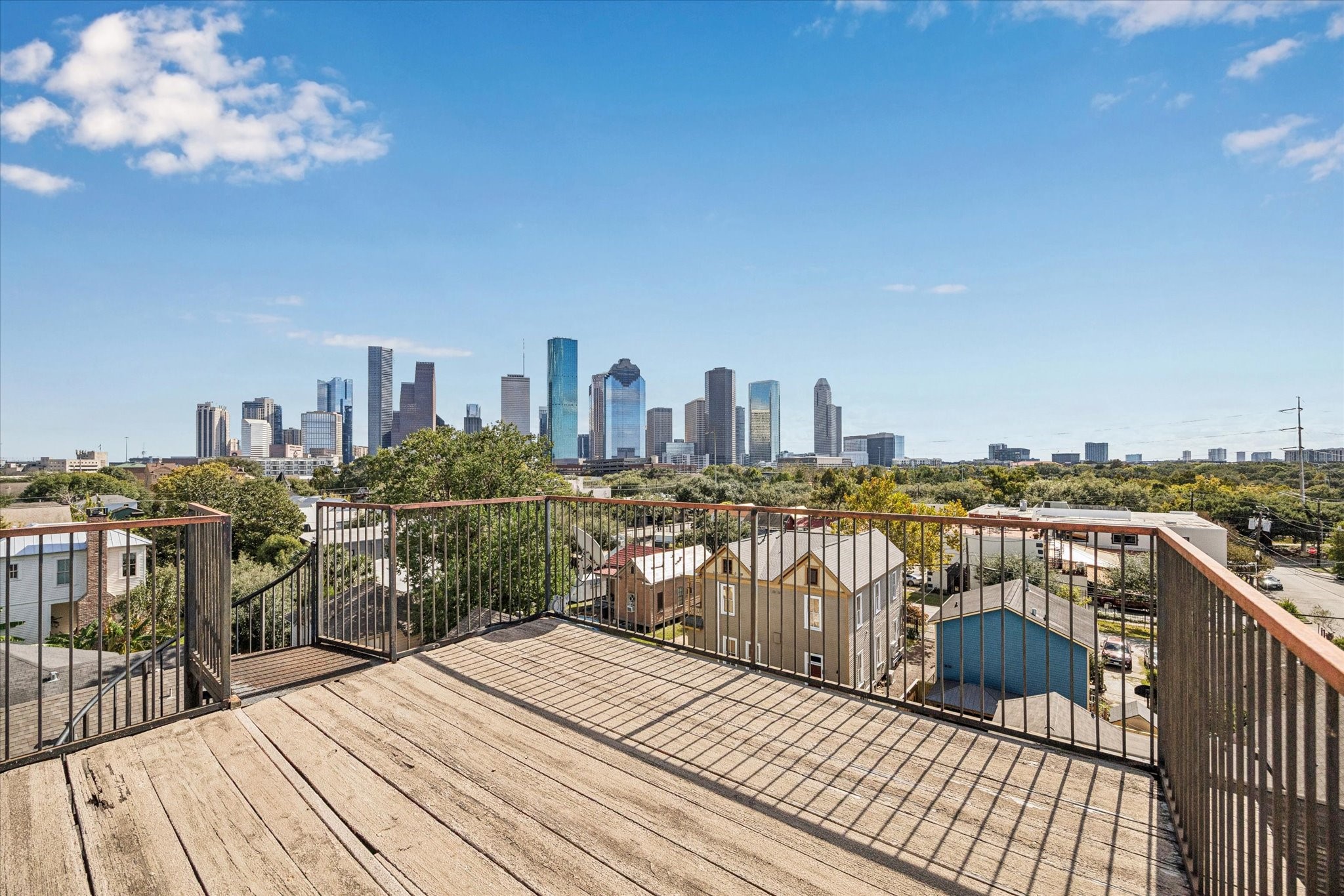 1919 Lubbock Street Houston, TX 77007 - Photo 31 of 36 a view of roof deck with a barbeque and wooden stairs