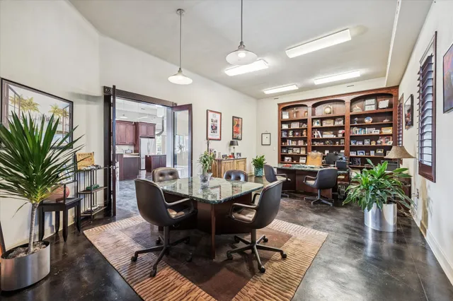 a living room with furniture and flowers