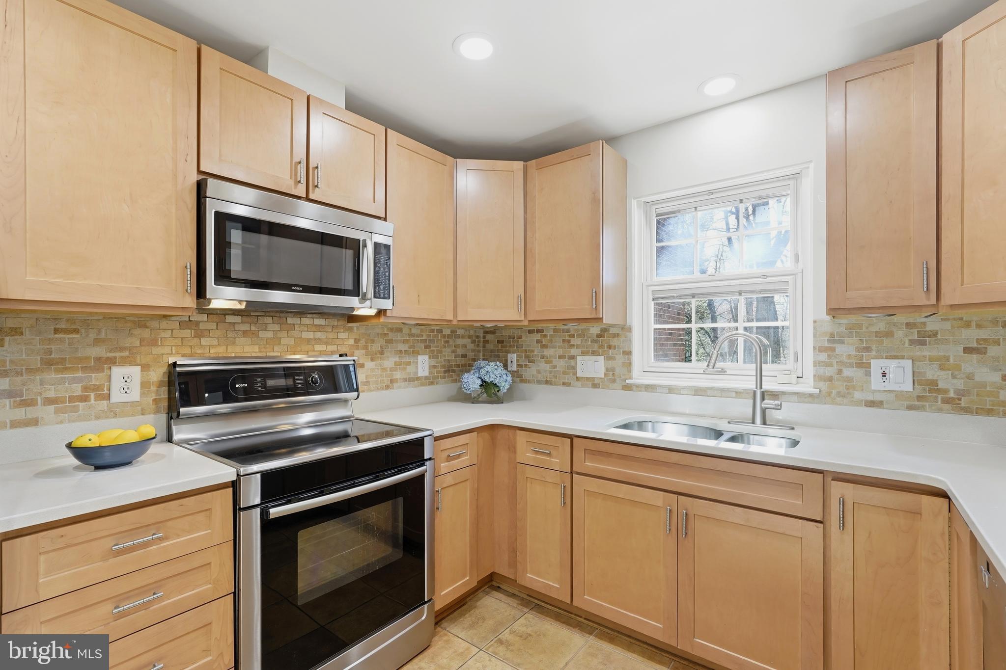 1472 Park Garden Lane Reston, VA 20194 - Photo 15 of 64 a kitchen with stainless steel appliances granite countertop a sink stove microwave and refrigerator