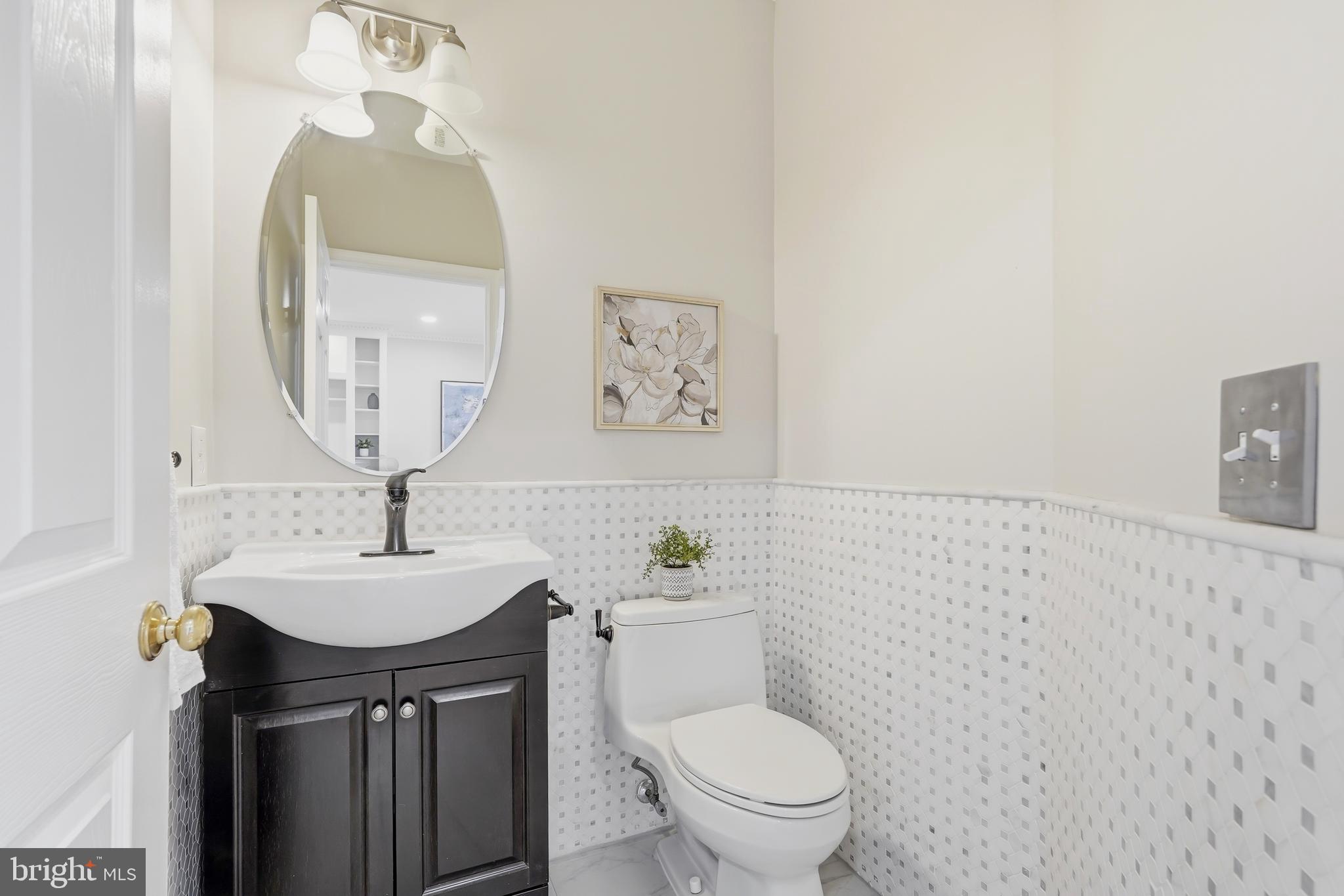 1472 Park Garden Lane Reston, VA 20194 - Photo 25 of 64 a bathroom with a sink a toilet and a mirror