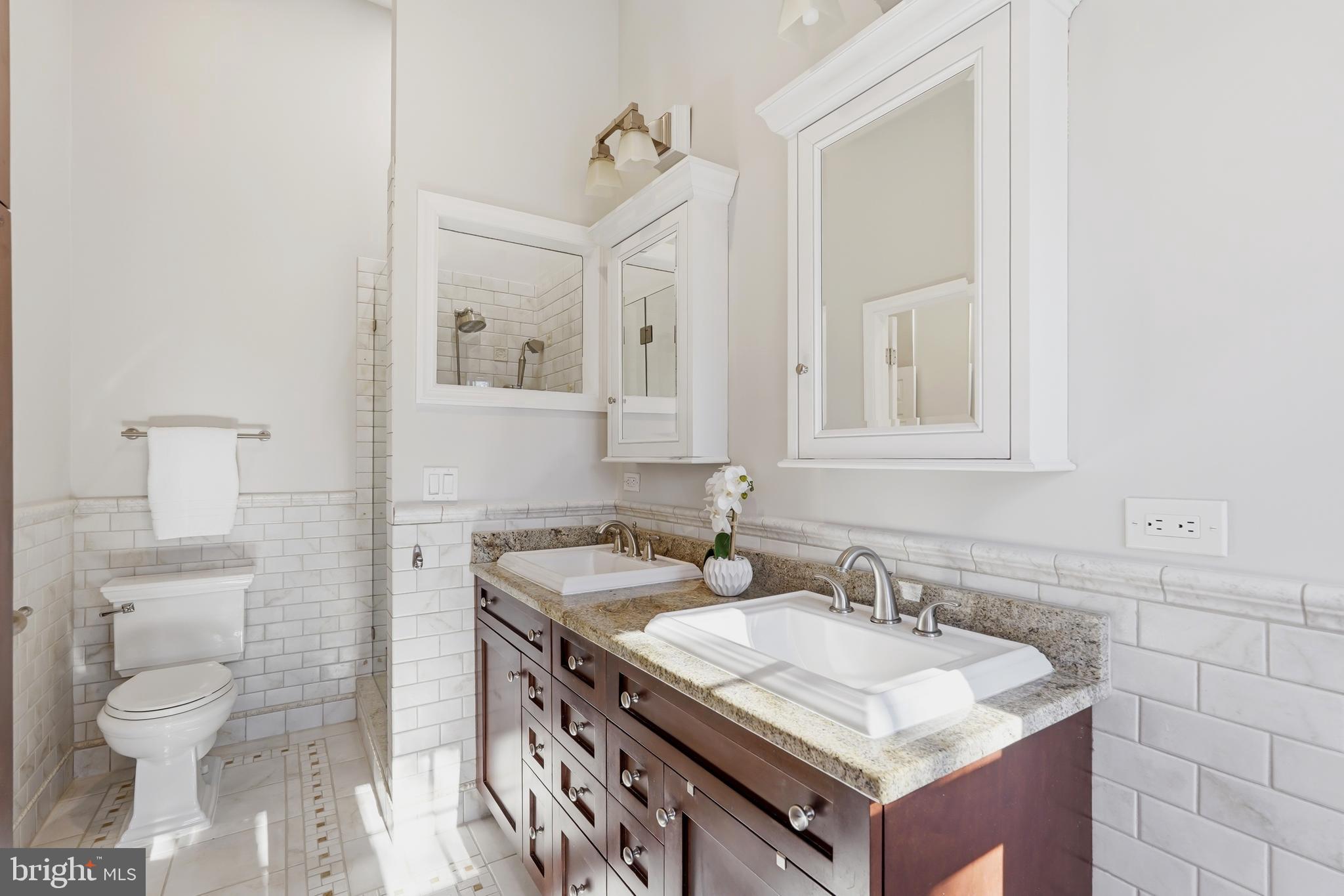 1472 Park Garden Lane Reston, VA 20194 - Photo 30 of 64 a bathroom with a granite countertop sink a toilet and a mirror
