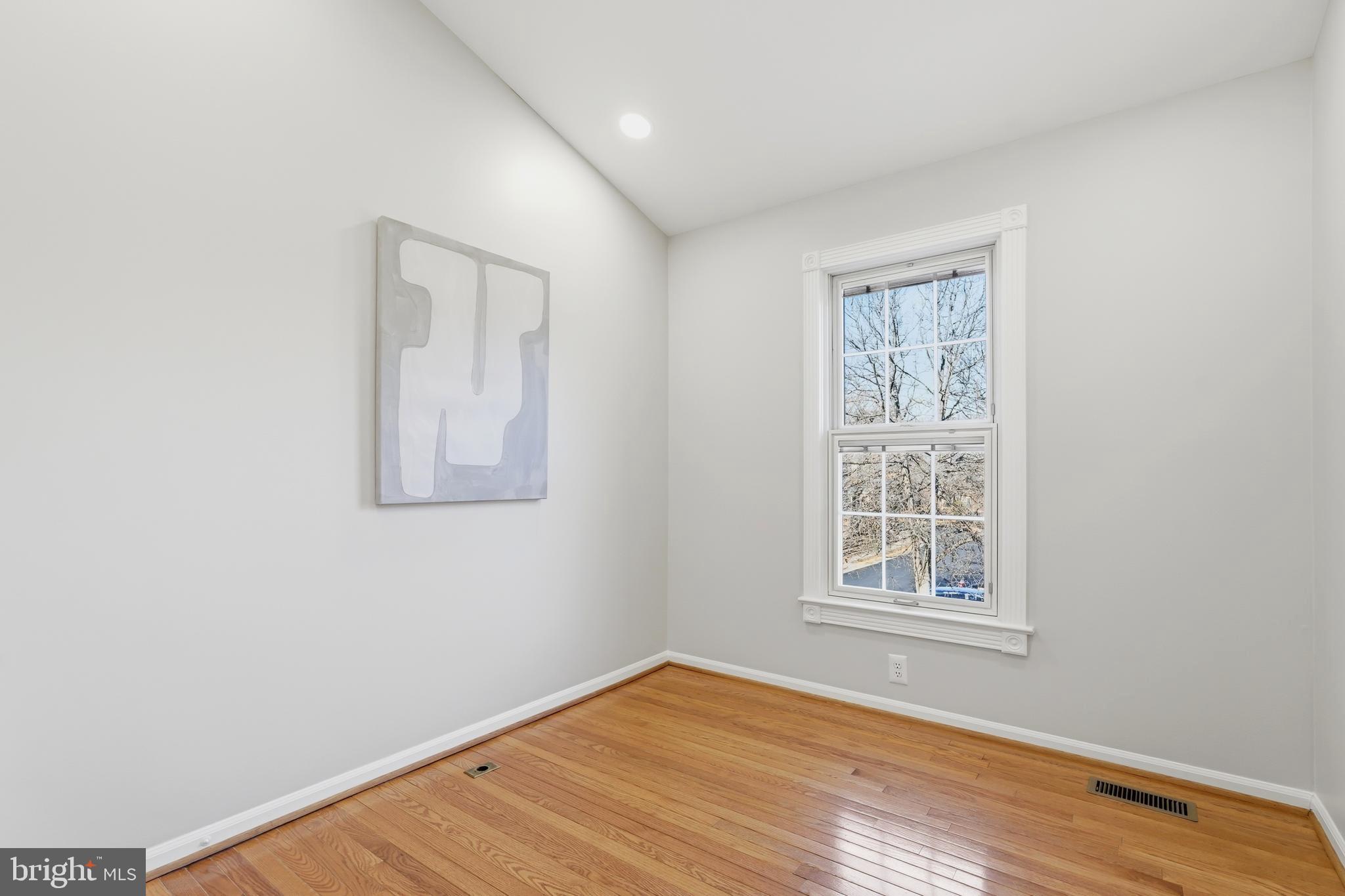 1472 Park Garden Lane Reston, VA 20194 - Photo 45 of 64 an empty room with wooden floor and windows